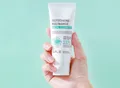 Front of the cleanser tube in hand